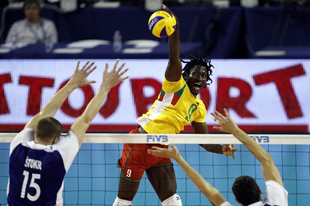 Cameroon's Ndongo spikes the ball against Czech Republic's Stokr and Vesely in Ancona